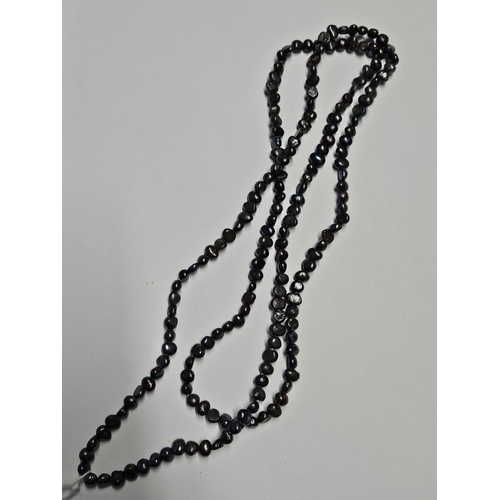 204 - A very long string of Black cultured Pearls.