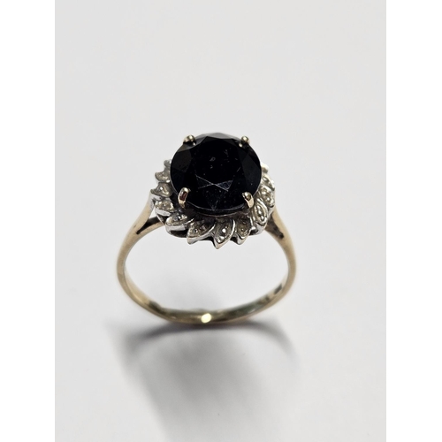 207 - A large Sapphire Ring, surrounded with Diamonds set in Gold, size S1/2.