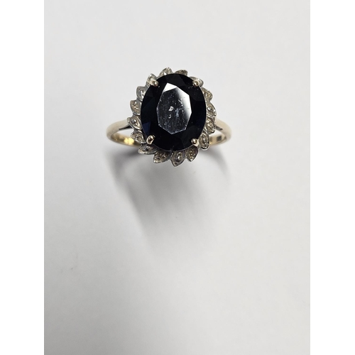 207 - A large Sapphire Ring, surrounded with Diamonds set in Gold, size S1/2.