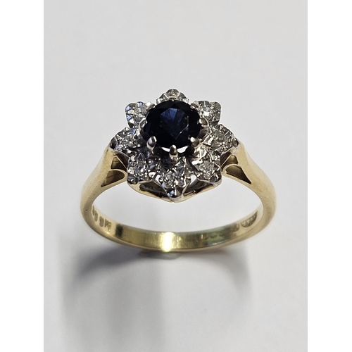 211 - An 18ct Gold, Diamond and Sapphire cluster Ring, size M.