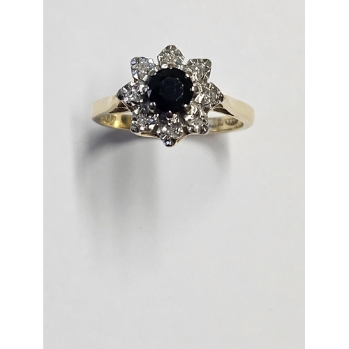 211 - An 18ct Gold, Diamond and Sapphire cluster Ring, size M.