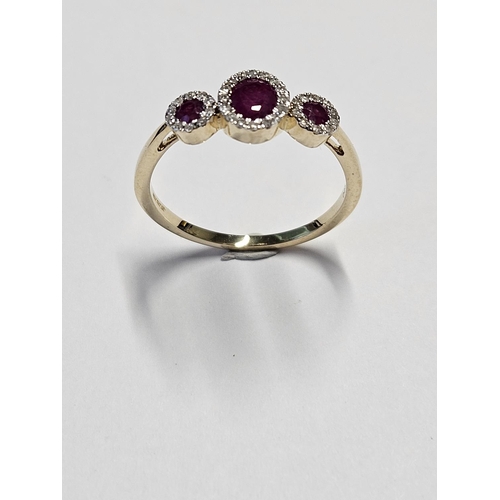 213 - A 9ct Gold, Diamond and Ruby triple cluster Ring, size O1/2.