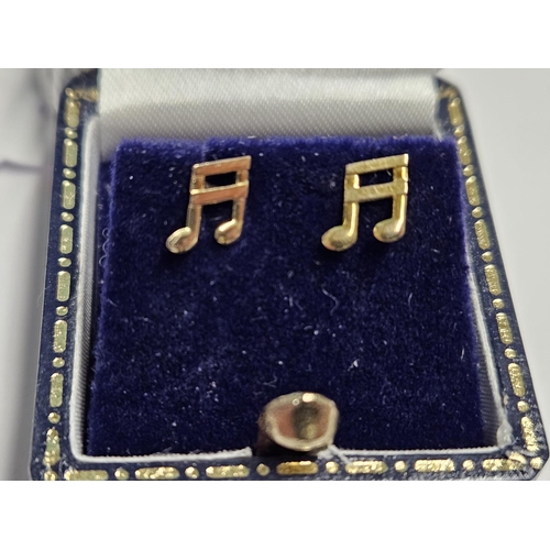 225 - A pair of 9ct Gold Earrings with a musical theme.