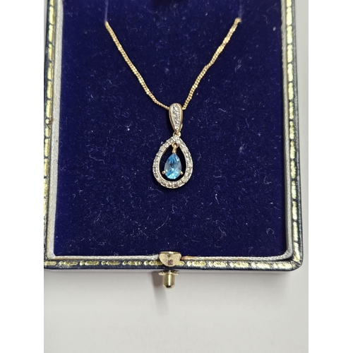 226 - A 9ct Gold, Diamond and Topaz Pendant with a 9ct Gold Chain.