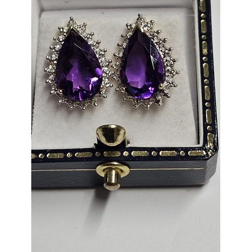 243 - A lovely pair of Gold, Diamond and Amethyst cluster Earrings.