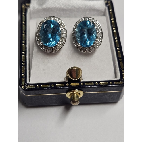 248 - A large pair of Gold, Diamond and Topaz cluster Earrings.