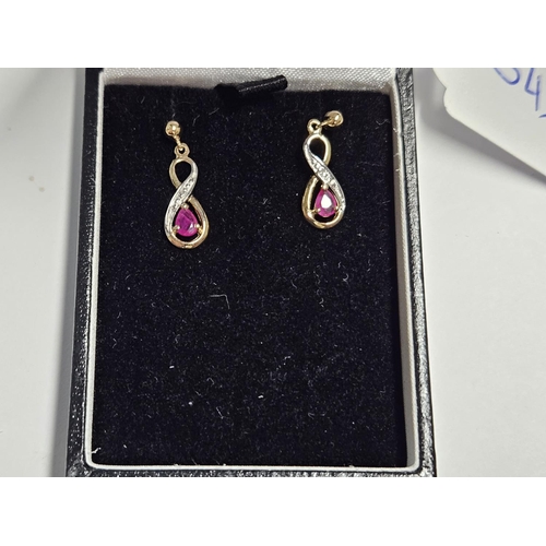 253 - A pair of 9ct Gold, Diamond and Ruby drop Earrings.