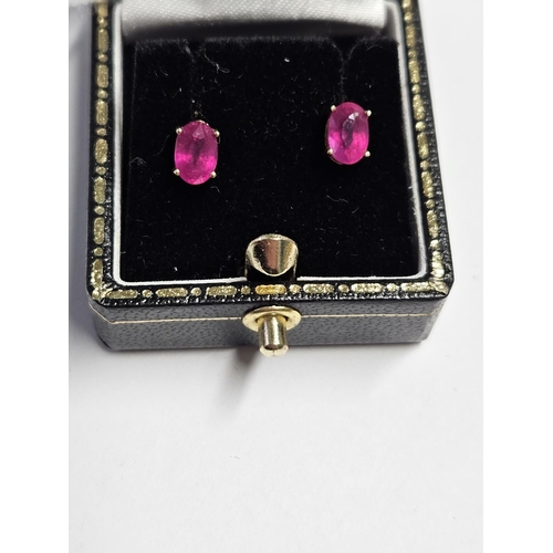 275 - A pair of Ruby solitaire Earrings set in Gold.