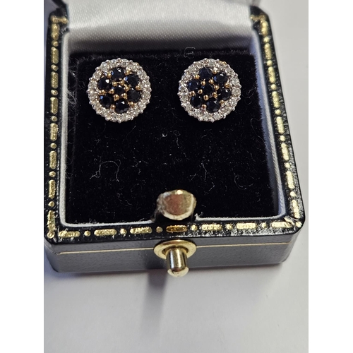 284 - A pair of 9ct Gold, Diamond and Sapphire cluster Earrings.