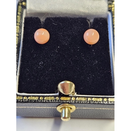 290 - A pair of Coral stud Earrings set in Gold.