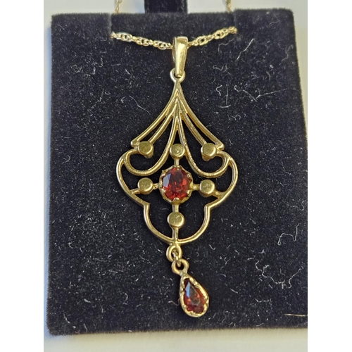 293 - A pair of 9ct Gold and Ruby pierced Pendant with a 9ct Gold Chain.