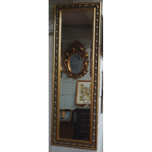 773 - A modern rectangular Gilt Mirror with highly moulded surround and bevelled glass. 128 x 42 cm approx... 