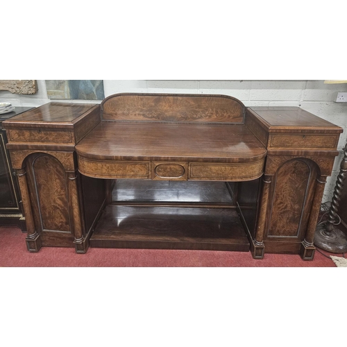 86 - An early 19th Century Mahogany Irish pedestal Sideboard with panel flame grain doors with turned col... 