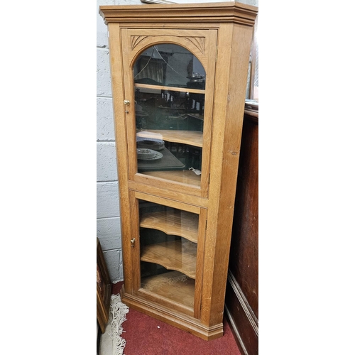 132 - A 20th Century Oak Corner Cabinet with glazed doors. W 69 x H 152 cm approx.