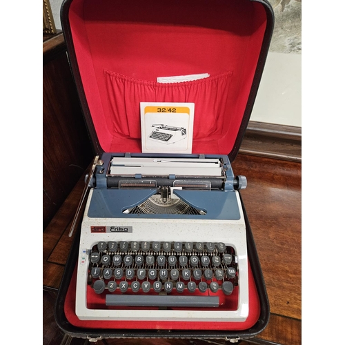 144 - A vintage Daro Erika Typewriter with instruction manual.