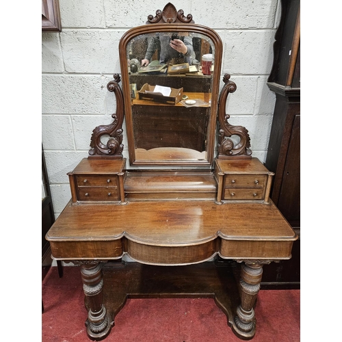 180 - A good Victorian Mahogany kneehole Dressing Table with bevelled mirrored back and drawered gallery t... 