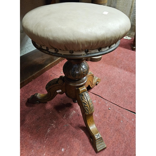 183 - An early 20th Century Oak Book Trough along with a 19th Century revolving piano Stool. Trough 
 W 46... 