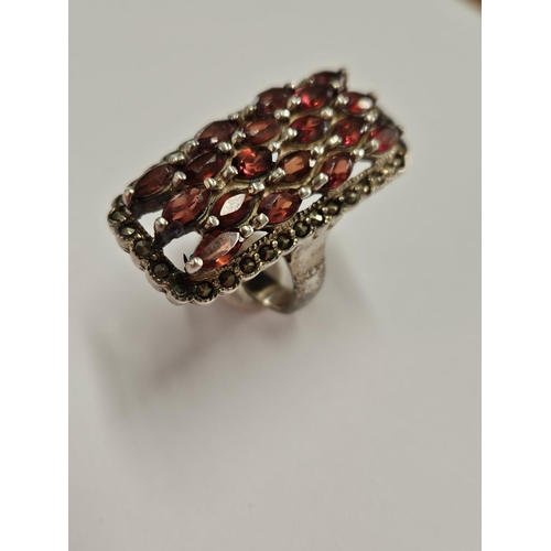 307 - A large Silver, Garnet and Marcasite Ring, size R.