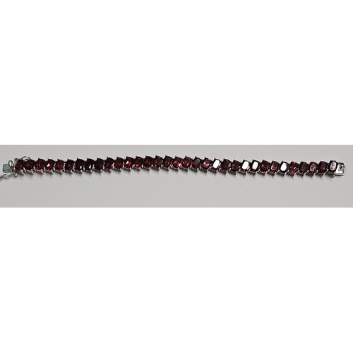 317 - A large Silver and Garnet line Bracelet.