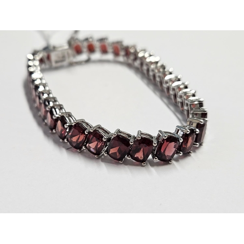 317 - A large Silver and Garnet line Bracelet.