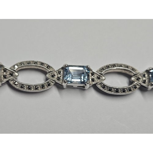 335 - A Silver and Topaz Bracelet in the antique style.