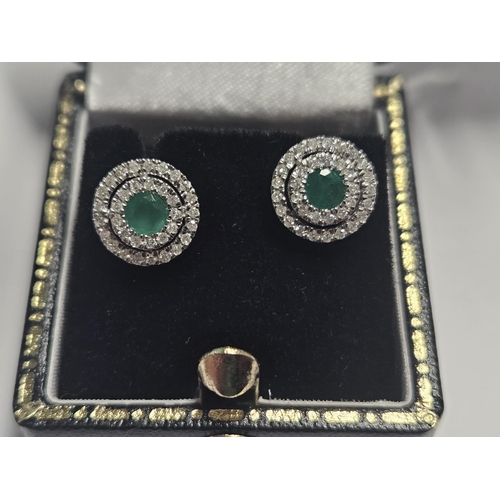 340 - A lovely pair of Emerald and Diamond 'target' Earrings set in White Gold.