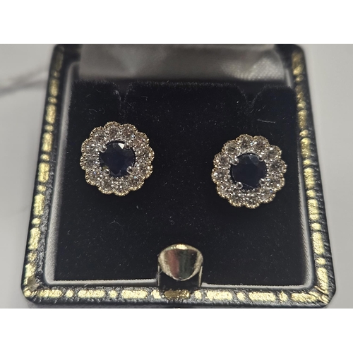 342 - A pair of Gold, Diamond and Sapphire cluster Earrings.