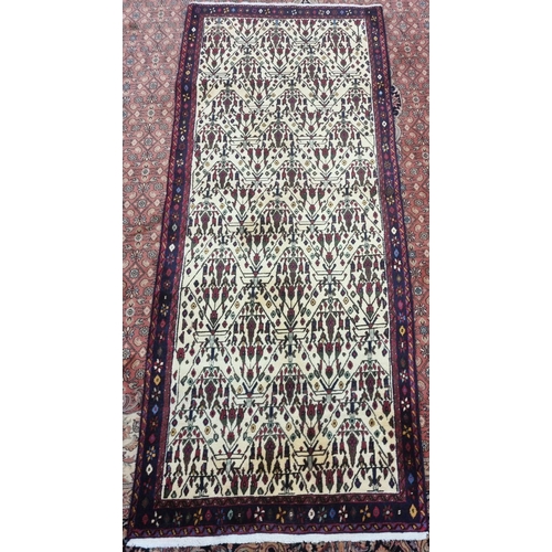 654 - A Cream ground Persian Baluchi nomadic Runner with a unique all over design, 240 x 100 cms approx.