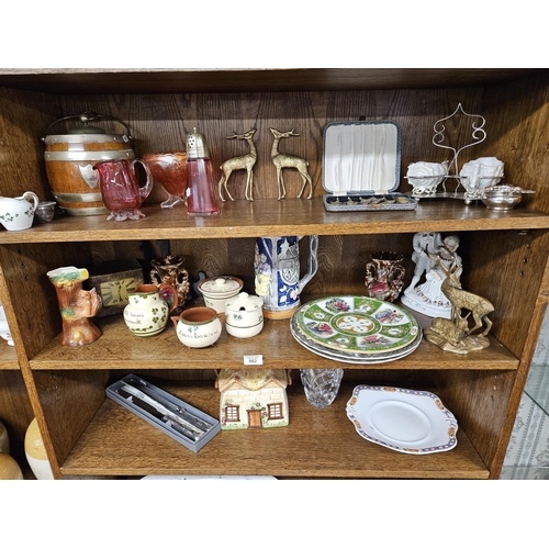 662 - A good quantity of decorative Items on four shelves to include a biscuit barrel, spoons, large Stein... 