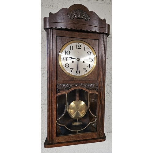 712 - An early 20th Century Oak Wall Clock. W 33 x H 75 cm approx.