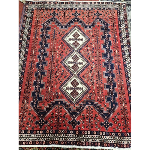 727 - A good Persian burgundy ground Carpet with unique medallion design. 208 x 160cm approx.