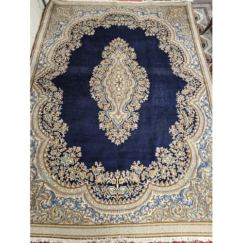 728 - A good Persian blue ground Kerman Carpet with multi borders and unique medallion design. 311 x 224cm... 