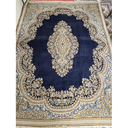 728 - A good Persian blue ground Kerman Carpet with multi borders and unique medallion design. 311 x 224cm... 