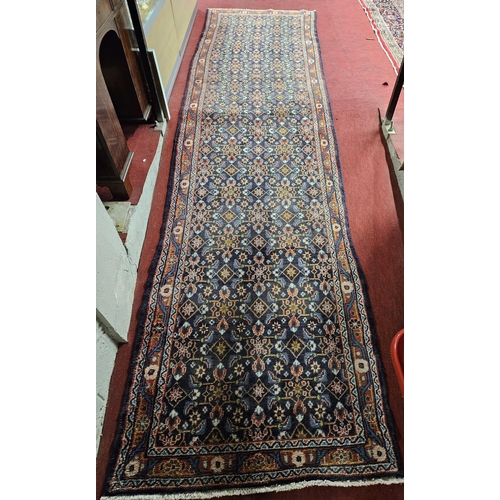 824 - A large and long deep Blue ground Persian Sarouk Runner with an all over pattern design. 417 x 114cm... 