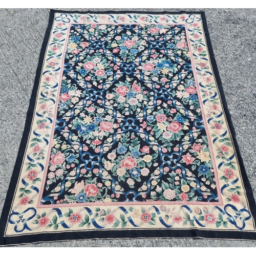 979 - A good Aubusson design Carpet/Wall Hanging with black ground and floral design 274 x 183 cm approx.