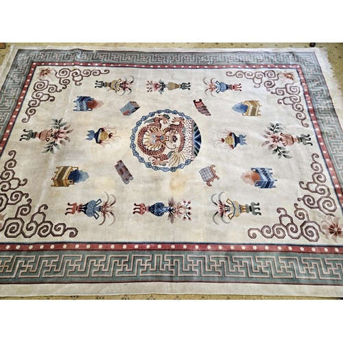 989 - A cream ground Oriental Carpet with Greek key border design. 244 x 345 cm approx.