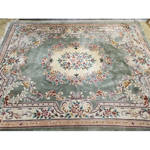 990 - An Oriental green ground Carpet with multi borders and all over floral design. 244 x 315 cm approx.