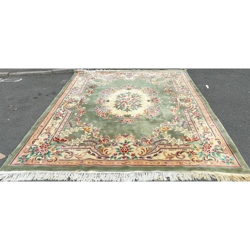 990 - An Oriental green ground Carpet with multi borders and all over floral design. 244 x 315 cm approx.