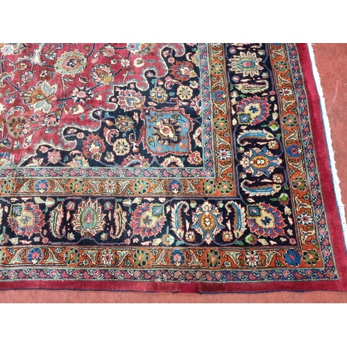 1051 - A deep Red ground Marshfield Carpet with a central medallion design and a deep border. 395 x 300 cm ... 