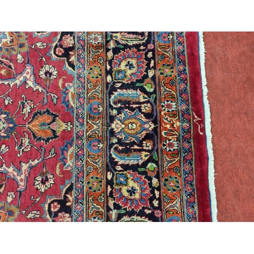 1051 - A deep Red ground Marshfield Carpet with a central medallion design and a deep border. 395 x 300 cm ... 