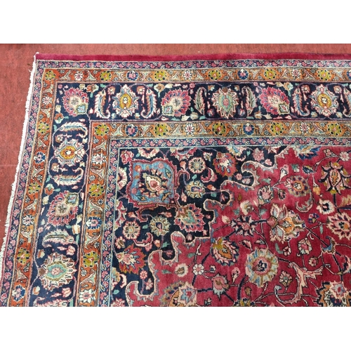 1051 - A deep Red ground Marshfield Carpet with a central medallion design and a deep border. 395 x 300 cm ... 