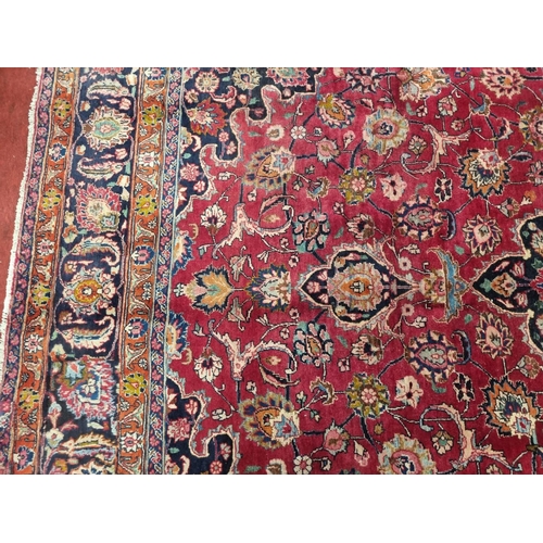 1051 - A deep Red ground Marshfield Carpet with a central medallion design and a deep border. 395 x 300 cm ... 