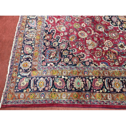 1051 - A deep Red ground Marshfield Carpet with a central medallion design and a deep border. 395 x 300 cm ... 