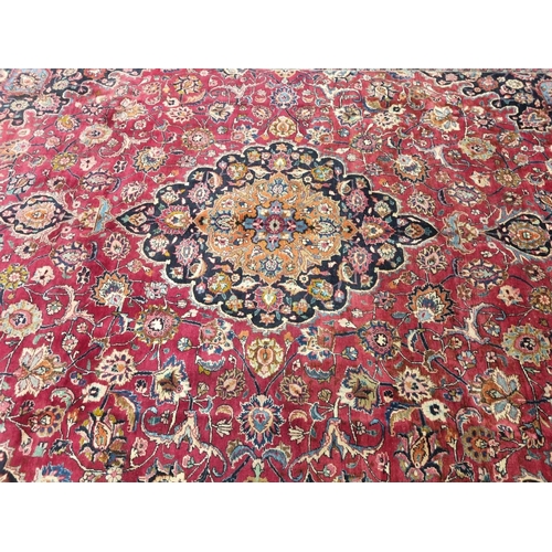 1051 - A deep Red ground Marshfield Carpet with a central medallion design and a deep border. 395 x 300 cm ... 