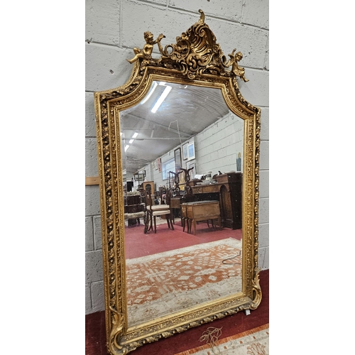 70 - A Fabulous Timber and plaster gilt overmantel Mirror with a highly moulded outline depiction cherubs... 