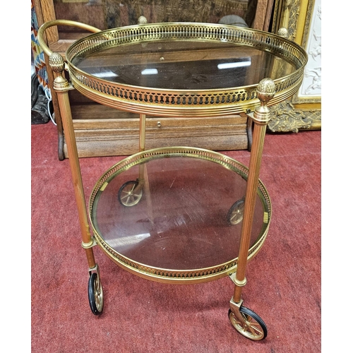 135 - A 20th Century Brass circular two tier Trolly.
H 62 x D 54 cm approx.