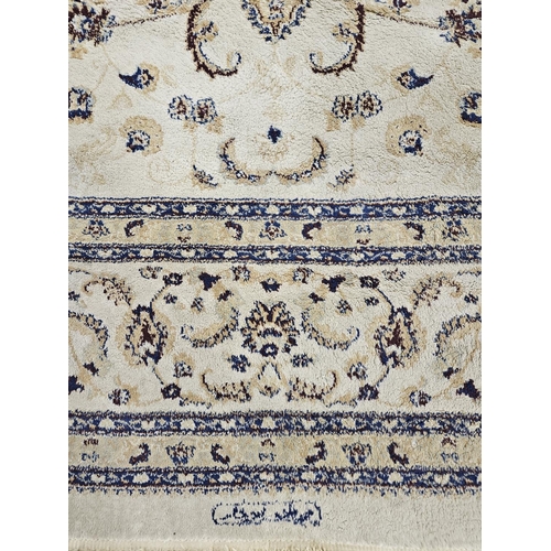 415 - An Ivory ground Carpet with central medallion design and multi borders.