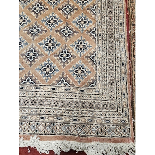 419 - A Pink/Salmon ground Rug with repeating design.
L 235 x W 156 cm approx.