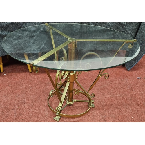 614 - A circular glass topped coffee Table. D 76 x H 49.5 cm approx.