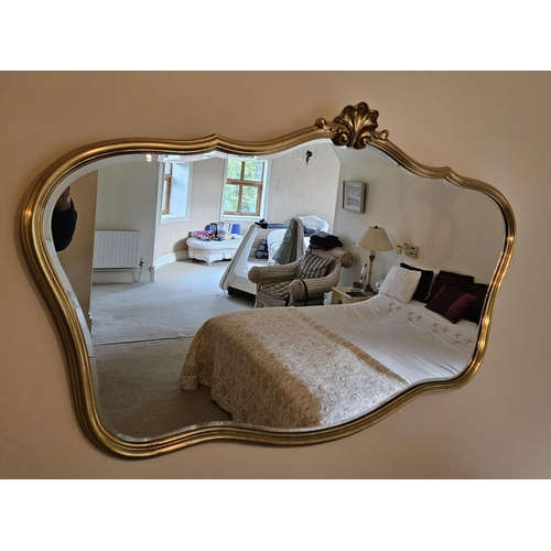 128 - A 20th Century Timber and Plaster Gilt Mirror with shaped outline.
H 80 x W 123 cm approx.